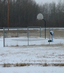 Laurie cleaning the court in a snowstorm!